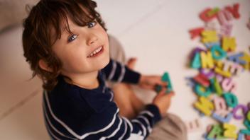 PreK boy playing with magnetic letters