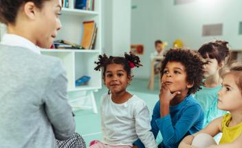 kindergarten teacher helping students make the sounds in words