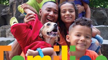 Joyful multiracial family with their dog