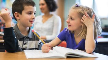 two elementary students talking about a text together