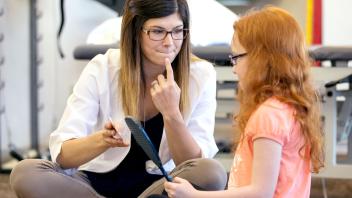 Speech therapist working on speech sounds with elementary student