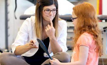 Speech therapist working on speech sounds with elementary student