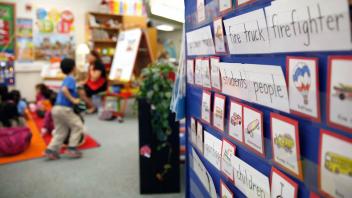 bulletin board in first grade classroom filled with vocabulary words